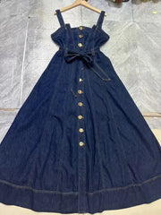 Full view of a denim midi dress laid flat with button front