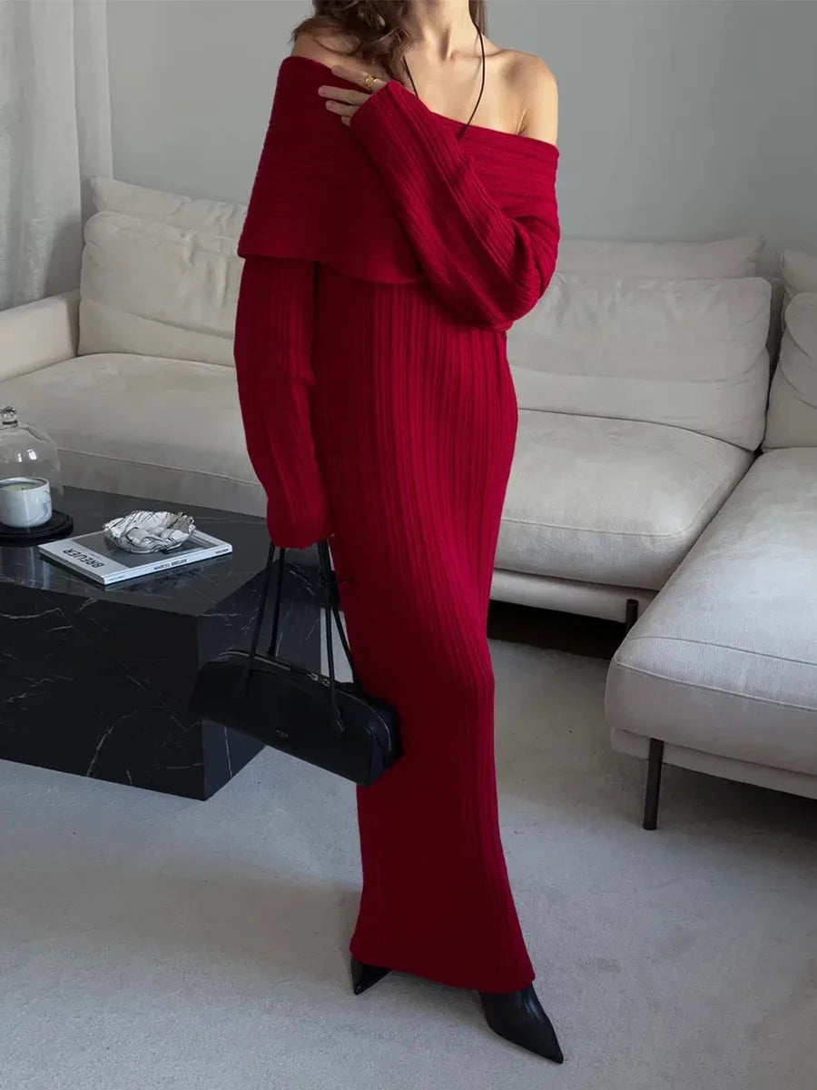 Person wearing a red off-shoulder outfit in a living room setting.