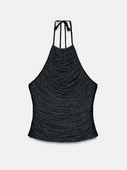 Black halter top with ruched design on a light gray background
