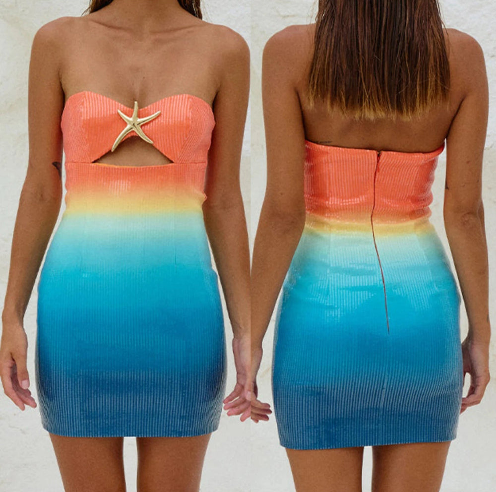 Gradient strapless dress with starfish detail on a plain background
