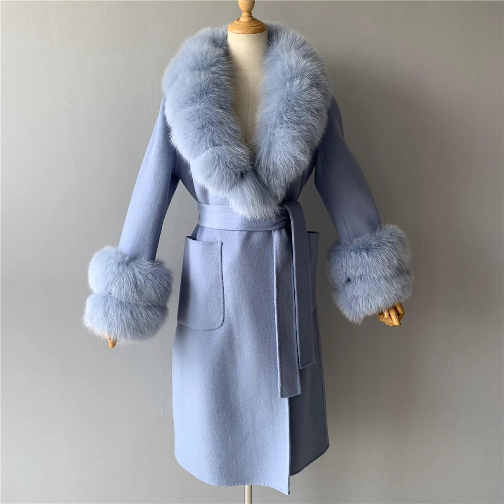 Light blue coat with fur trim on a mannequin against a plain background