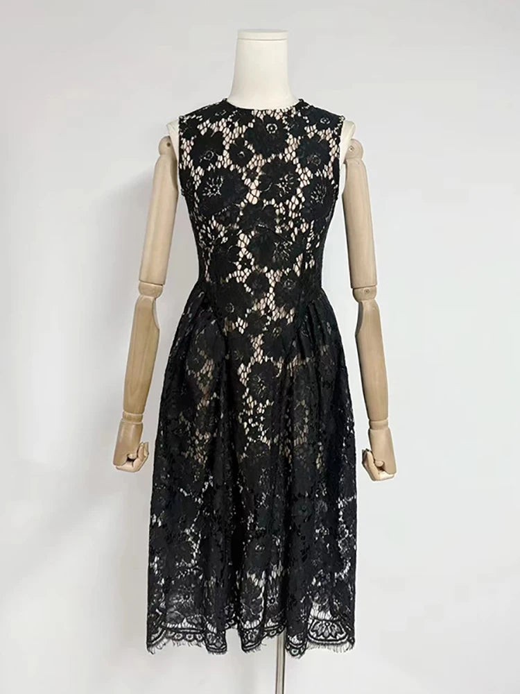 Black lace dress on a mannequin against a white background