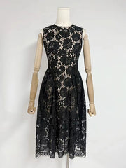 Black lace dress on a mannequin against a white background