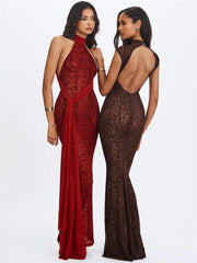 Two women wearing red and brown lace evening gowns on a white background