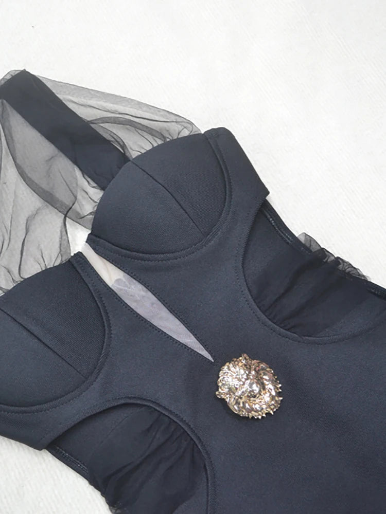 Navy blue swimsuit with a decorative brooch on a white background