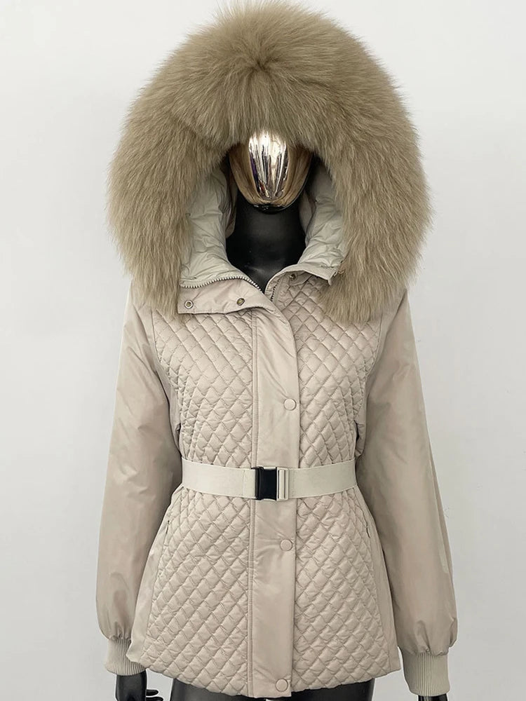Beige quilted jacket with large fur hood on a mannequin against a white background