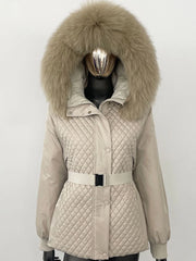Beige quilted jacket with large fur hood on a mannequin against a white background