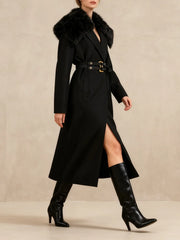 Woman wearing a black coat with fur collar and black knee-high boots on a beige background