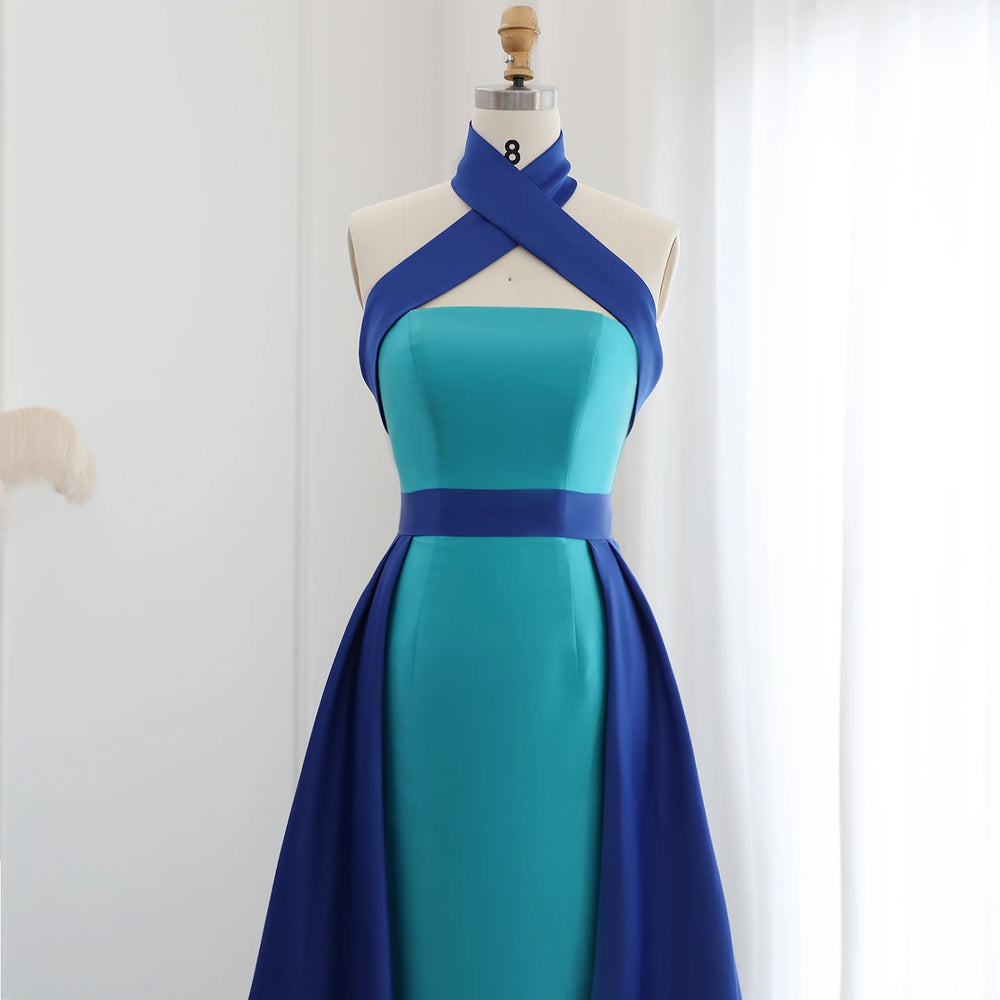 Blue and green dress on a mannequin against a white background
