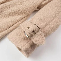 Beige fleece blanket with a buckle on a white background