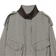 Black and white checkered shirt with a brown collar on a white background