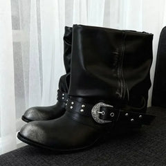 Black slouch ankle boots with a distressed metallic toe cap and decorative buckle strap.