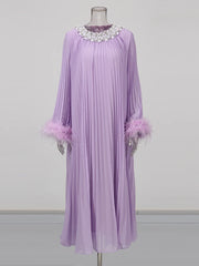 Lavender dress with embellishments on a mannequin against a gray background