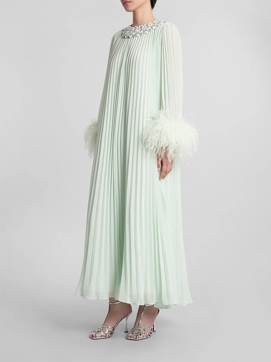 Light green dress with feathered sleeves on a white background