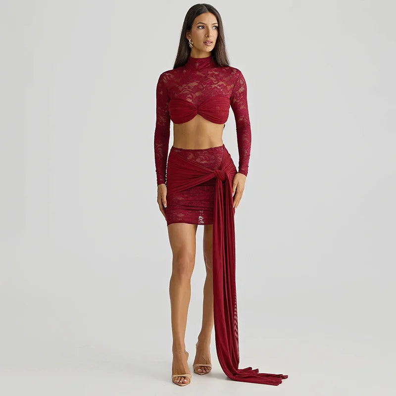 Woman wearing a red lace outfit on a plain background