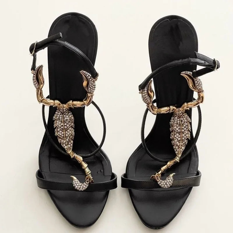Black stiletto heel with gold scorpion embellishment and crystal details