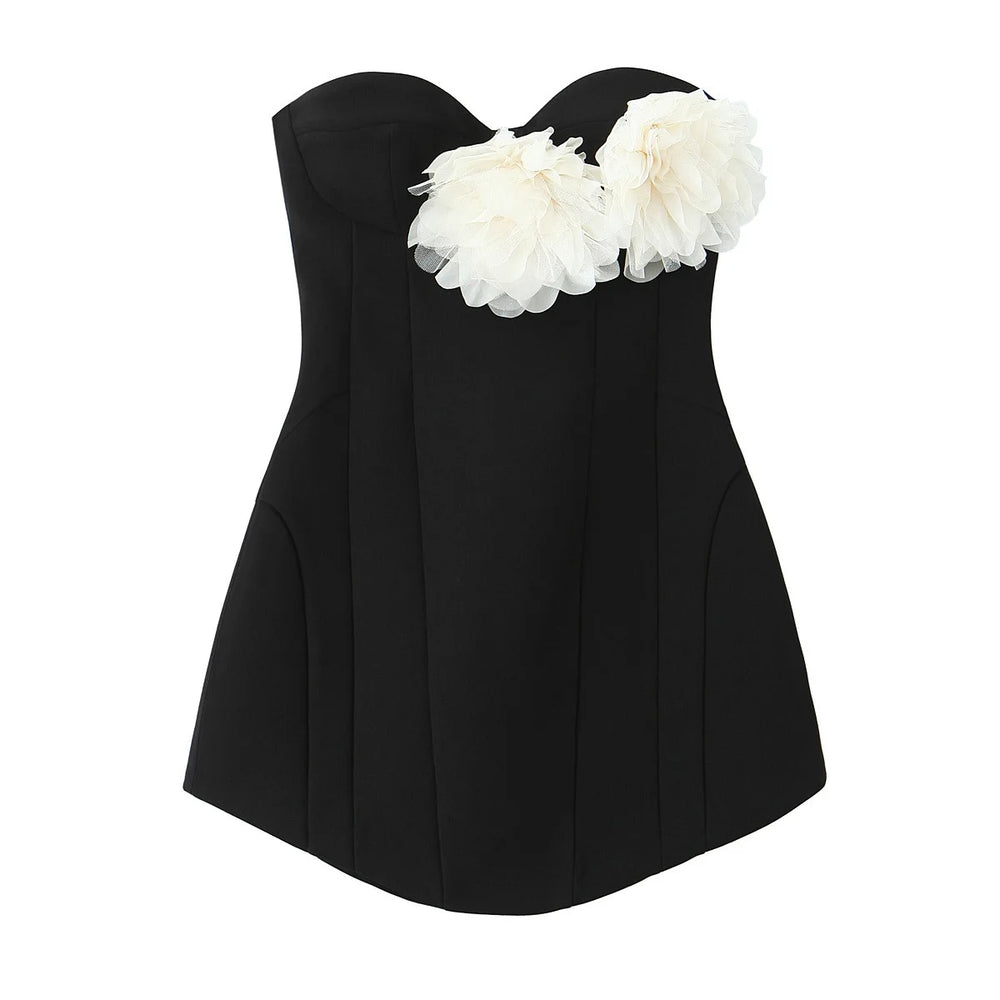 Black strapless top with white floral embellishments on a white background