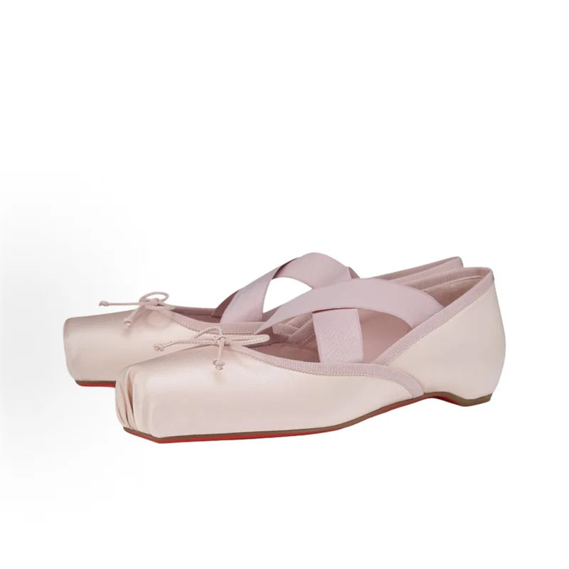 Pair of pink ballet shoes on a white background