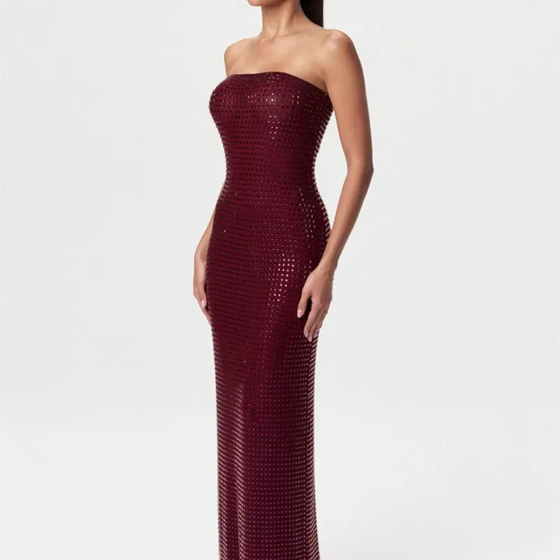 Maroon strapless gown with sequin detailing on a white background