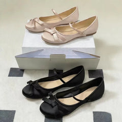 Pair of black satin mary jane ballet flats with bow detail
