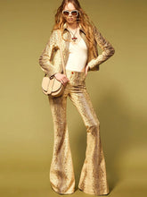 Model wearing a snake print leather-look jacket and flare pants set.