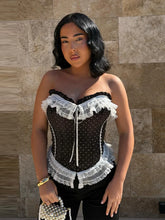 Black polka dot corset top with white lace trim and sweetheart neckline.