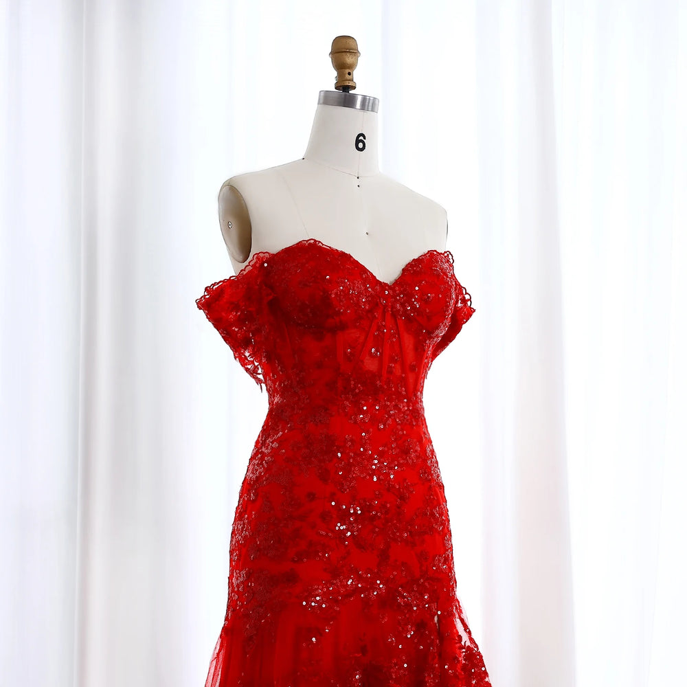 Red beaded dress on a mannequin against a white background
