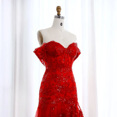 Red beaded dress on a mannequin against a white background
