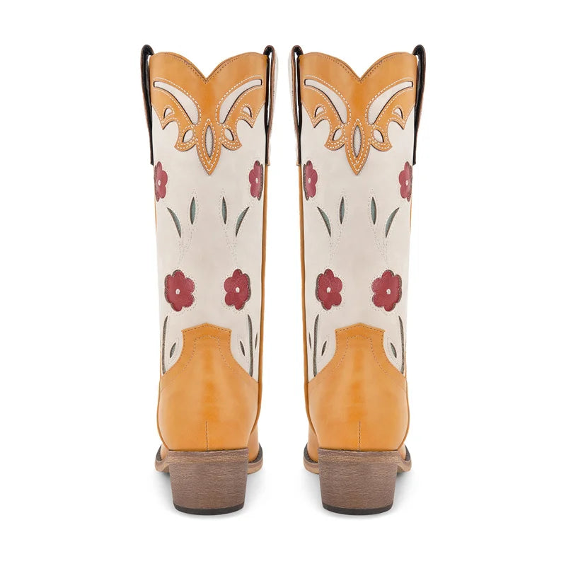 Pair of cowboy boots with floral patterns on a white background