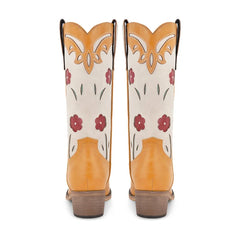 Pair of cowboy boots with floral patterns on a white background