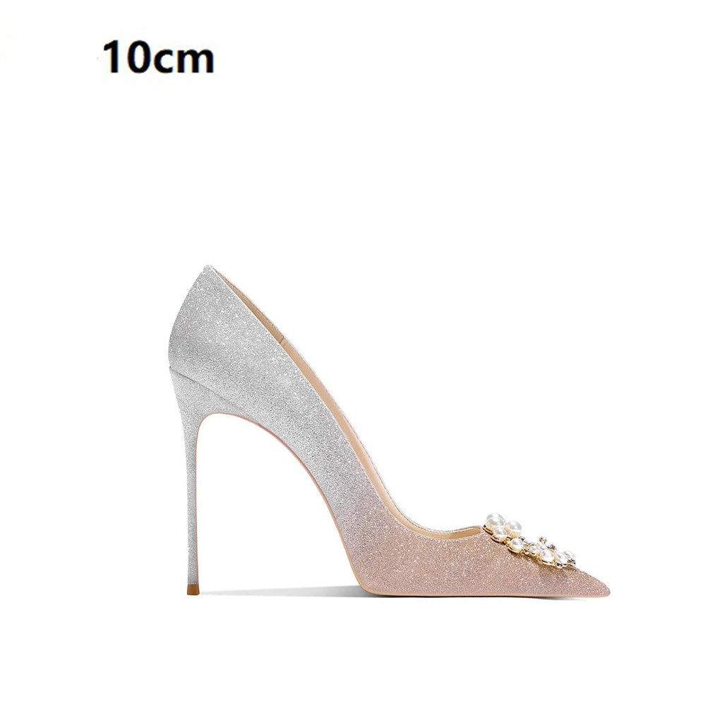 Silver high-heeled shoe with decorative elements on a white background