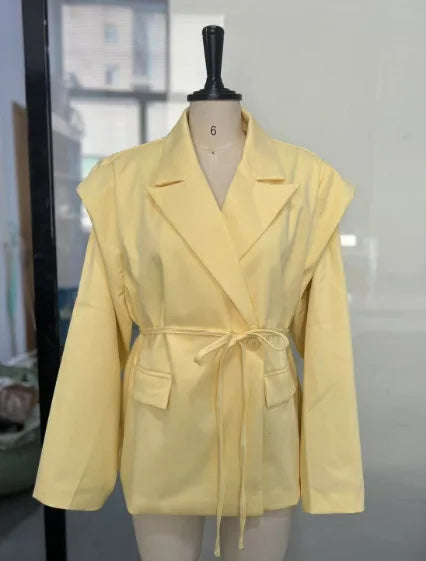 Yellow jacket on a mannequin against a neutral background