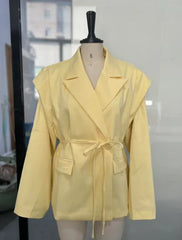 Yellow jacket on a mannequin against a neutral background