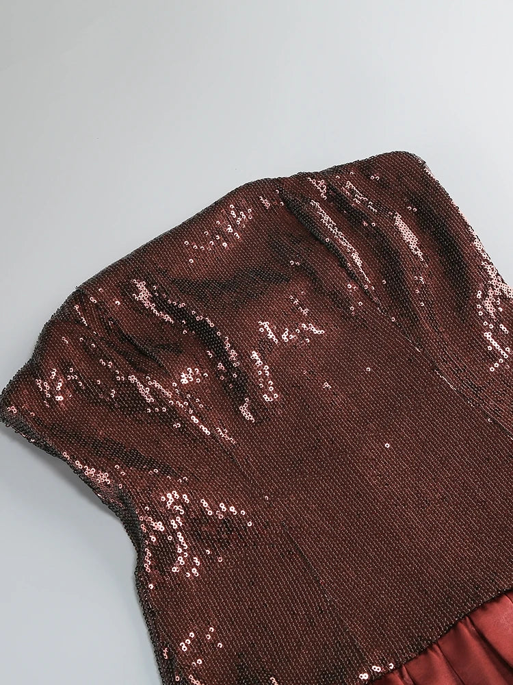 Close-up of brown sequin fabric on a gray background