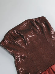 Close-up of brown sequin fabric on a gray background