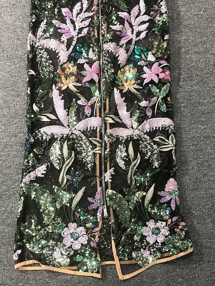 Embroidered floral and leaf pattern on a black background