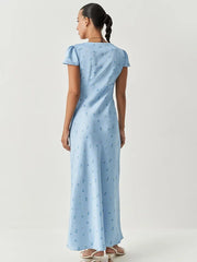 The back view of the dress, showing the flowing A-line silhouette.