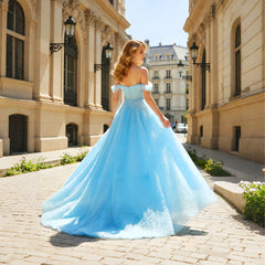 Side slit detail on a light blue tulle formal gown with a flowing A-line skirt