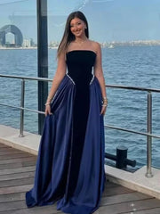 Floor-length A-line velvet gown with flare folds and natural evening drape captured in motion.