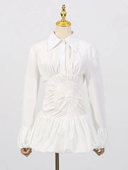 A-line white mini shirt dress styled for cocktail nights  on a mannequin against a white background