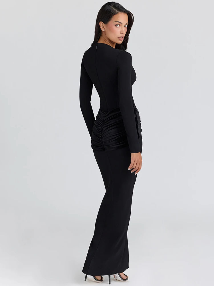 Side angle of a slim long-sleeve maxi dress with A-line release and refined walkability.