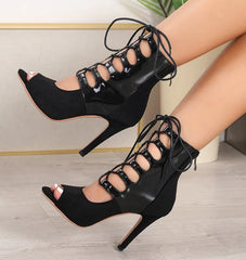 Open lace high-heel boot worn for occasion styling