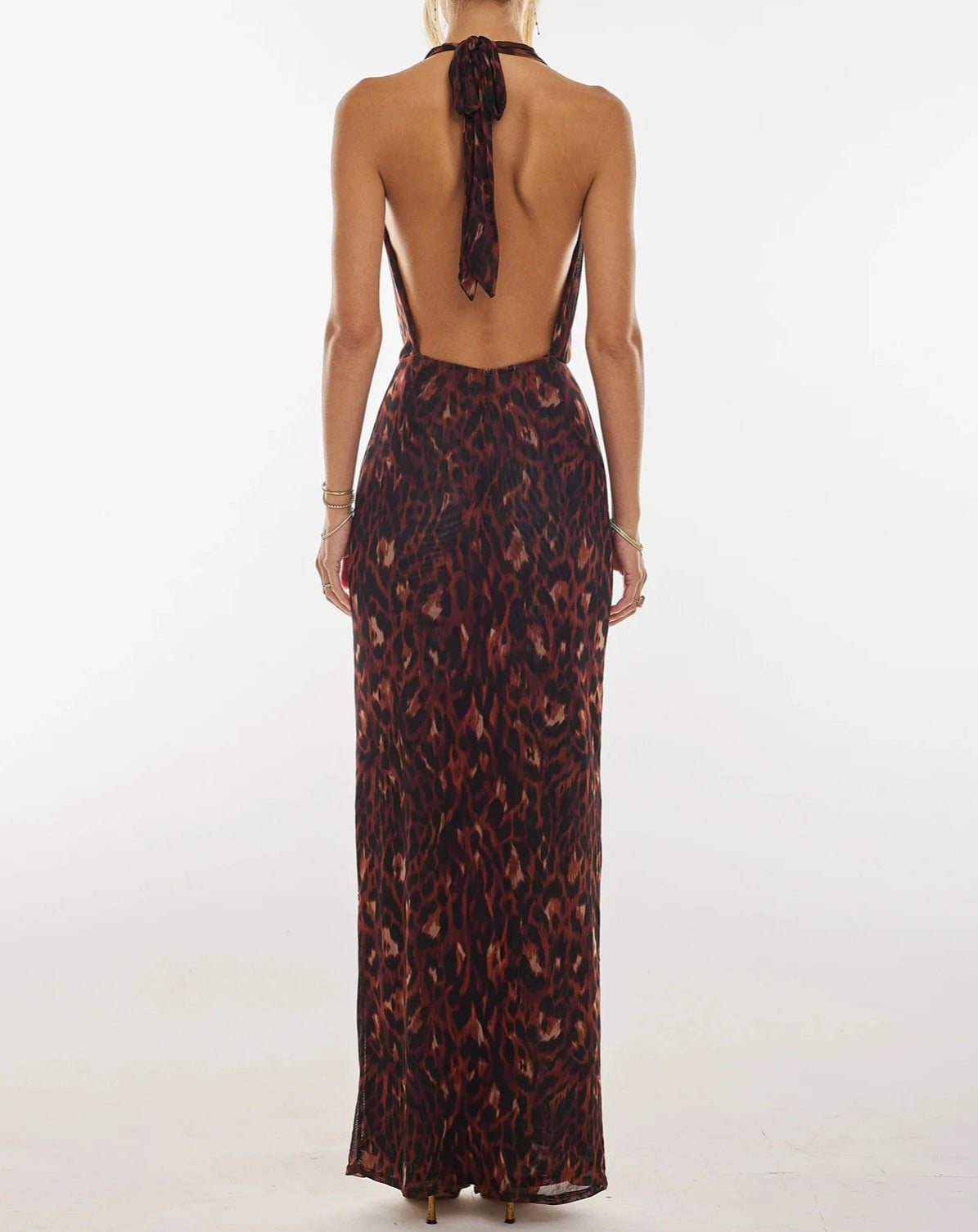 A full-length shot of the ankle-length floral halter gown.
