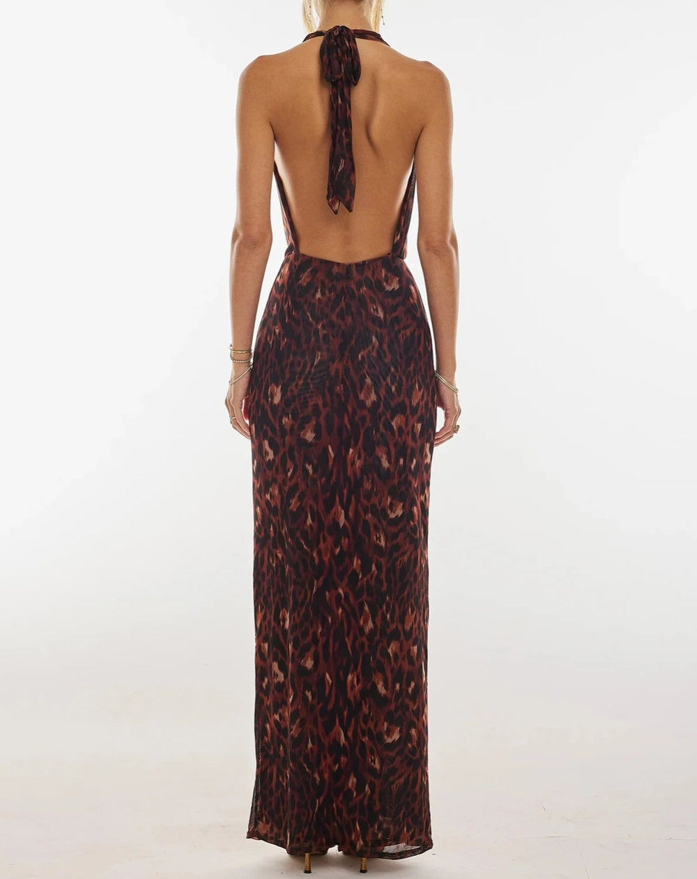 A full-length shot of the ankle-length floral halter gown.