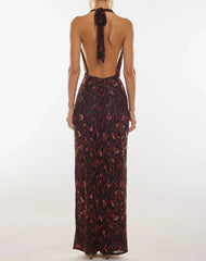 A full-length shot of the ankle-length floral halter gown.
