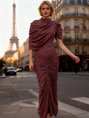 Full-length shot of a slim pleated maxi dress with sculpted ruching styled for an elegant evening walk through the city.