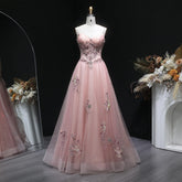 V-neck tulle A-line gown with appliqué detailing and slim straps