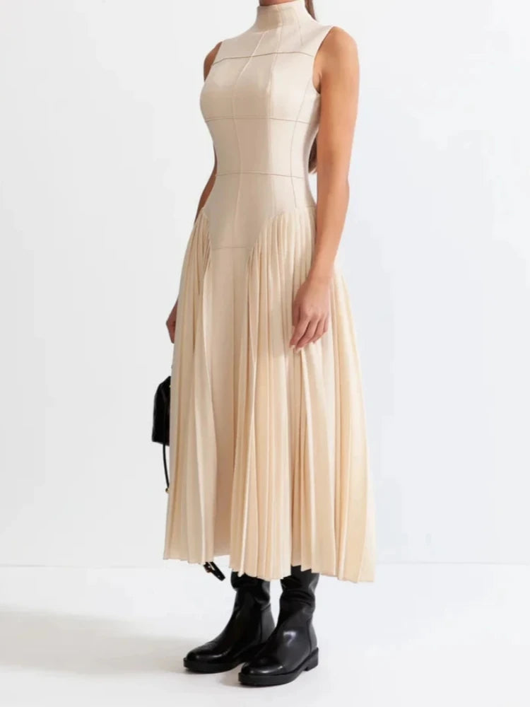 Side view of apricot A-line dress with structured pleats