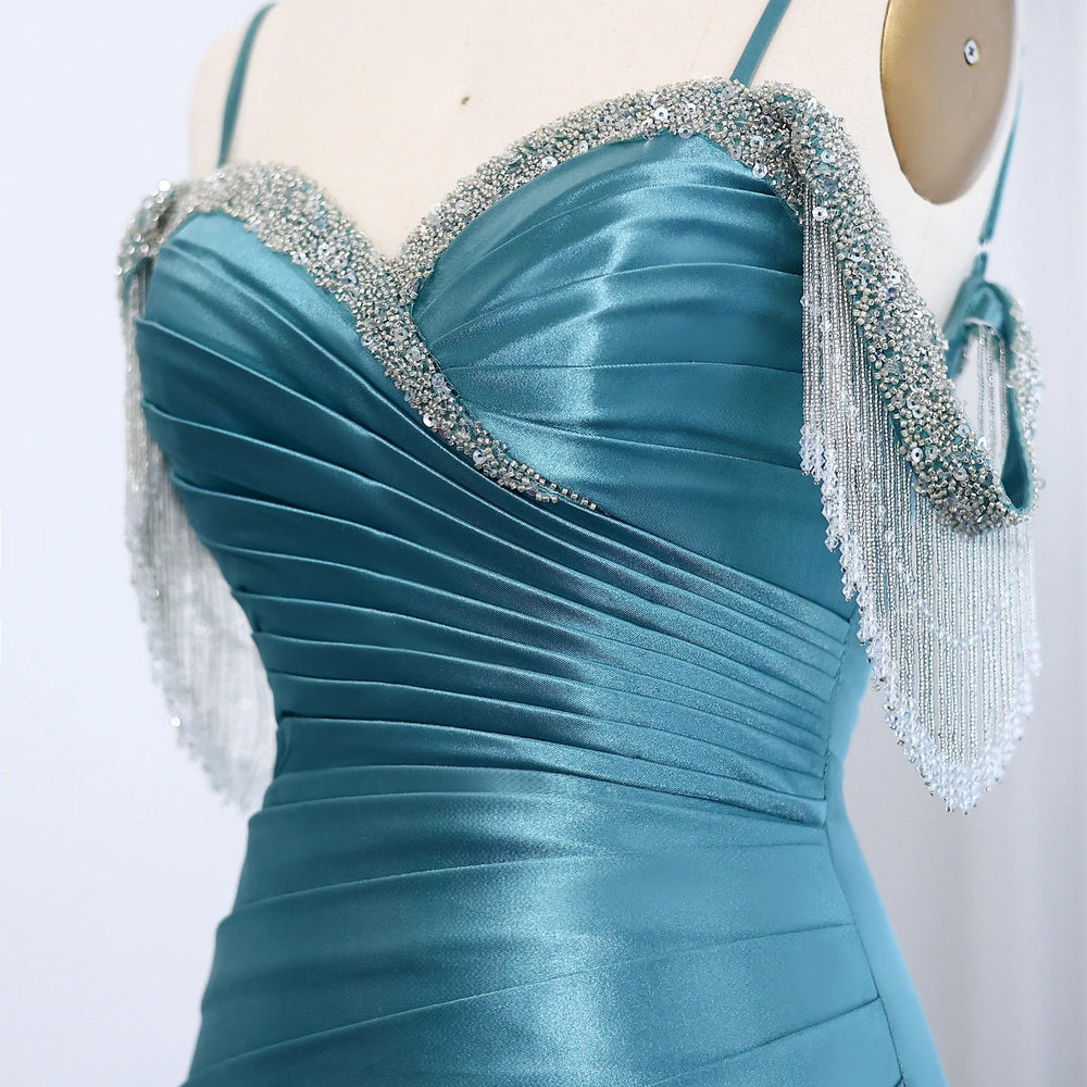 Detail of draped satin mermaid evening gown with slim shoulder straps