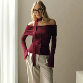 A close-up shot of the scarf ribbon and the sleek knit fabric texture.